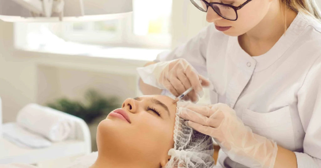 Professional woman in a lab coat giving a Sculptra injection in Scottsdale, AZ, to a client in a clean, well-lit clinic.