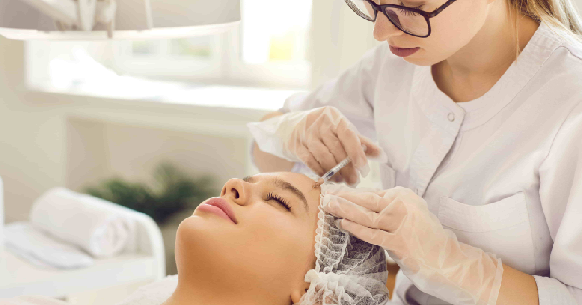 Professional woman in a lab coat giving a Sculptra injection in Scottsdale, AZ, to a client in a clean, well-lit clinic.